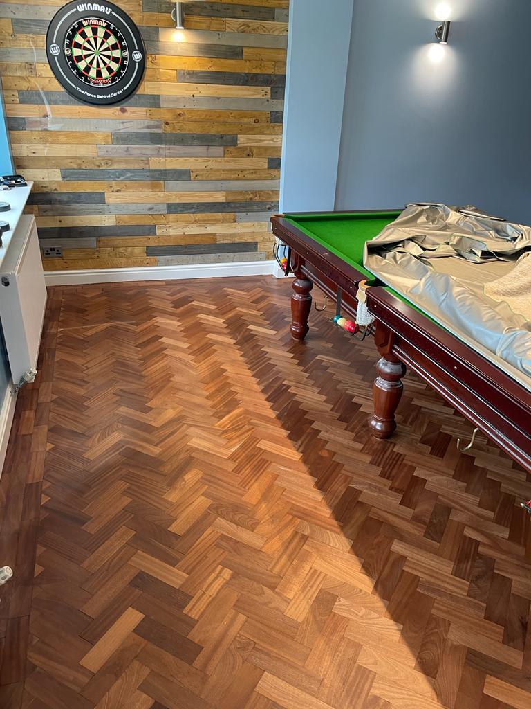 restored herringbone wood floor in games room